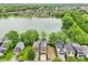 Picturesque aerial view of lakefront homes surrounded by lush greenery, highlighting serene community living at 2841 Tropical Dr, Indianapolis, IN 46205