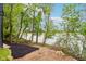 Scenic backyard view with mature trees and waterfront access, offering privacy and natural beauty at 2841 Tropical Dr, Indianapolis, IN 46205