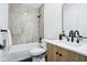 Stylish bathroom with a bathtub-shower, light wood vanity cabinet, marble counter-top, and matte black hardware at 2841 Tropical Dr, Indianapolis, IN 46205