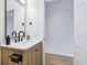 Bathroom showcasing a marble countertop vanity, matte black fixtures, wood cabinet, and wood-style laminate flooring at 2841 Tropical Dr, Indianapolis, IN 46205