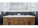 Bathroom features a modern vanity with dual sinks, a white countertop, and stylish light fixture at 2841 Tropical Dr, Indianapolis, IN 46205