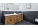 Bathroom boasts a modern vanity with dual sinks, a white countertop, and stylish light fixture at 2841 Tropical Dr, Indianapolis, IN 46205