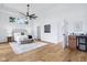 Bright bedroom with wood floors, ceiling fan, bedside tables, and mini-bar for convenience at 2841 Tropical Dr, Indianapolis, IN 46205