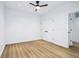 This bedroom features light wood floors, a ceiling fan, closet, and a bright interior, providing a serene atmosphere at 2841 Tropical Dr, Indianapolis, IN 46205