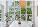 Bright dining area with large windows showcasing scenic views and a modern light fixture at 2841 Tropical Dr, Indianapolis, IN 46205