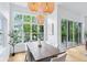 Dining space featuring modern light fixtures, natural light, and access to an outdoor deck at 2841 Tropical Dr, Indianapolis, IN 46205