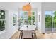 Elegant dining room with stylish pendant lighting, scenic views, and access to outdoor spaces at 2841 Tropical Dr, Indianapolis, IN 46205