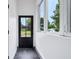 A spacious foyer with a black marble floor, white walls, and lots of natural light at 2841 Tropical Dr, Indianapolis, IN 46205