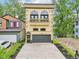 Charming home featuring a gray garage door, black-framed windows, a quaint balcony, and meticulous landscaping at 2841 Tropical Dr, Indianapolis, IN 46205
