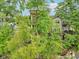 Three-story home with balconies surrounded by lush foliage, offering lake views at 2841 Tropical Dr, Indianapolis, IN 46205