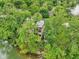 View of the home's exterior surrounded by mature trees and lake access at 2841 Tropical Dr, Indianapolis, IN 46205