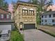 Beautiful three-story house with a balcony, gray garage door, and modern design at 2841 Tropical Dr, Indianapolis, IN 46205
