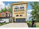 A two-story home showing the two-car garage and a small balcony at 2841 Tropical Dr, Indianapolis, IN 46205