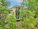 Modern three-story home featuring balconies, surrounded by mature trees at 2841 Tropical Dr, Indianapolis, IN 46205