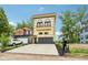 Charming three-story home with a balcony, landscaped front yard, and paved driveway at 2841 Tropical Dr, Indianapolis, IN 46205