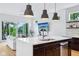 Kitchen island with stainless steel fixtures and appliances, quartz countertops, and views of the living area at 2841 Tropical Dr, Indianapolis, IN 46205