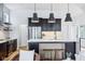 Modern kitchen with stainless steel appliances, dark wood cabinets, white quartz countertop, and wooden floors at 2841 Tropical Dr, Indianapolis, IN 46205