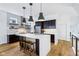 Modern kitchen with stainless steel appliances, dark wood cabinets, white quartz countertop, and wooden floors at 2841 Tropical Dr, Indianapolis, IN 46205
