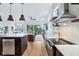Stylish kitchen with modern appliances and an open view to the living room and outdoor balcony at 2841 Tropical Dr, Indianapolis, IN 46205