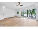 Bright, airy living room with lake views through large sliding glass doors, light wood floors, and modern ceiling fan at 2841 Tropical Dr, Indianapolis, IN 46205