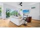 Comfortable living space with sleek ceiling fan, ample seating, and scenic views visible through the sliding glass door at 2841 Tropical Dr, Indianapolis, IN 46205
