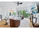 Bright, open-concept living room with large windows, hardwood floors, and modern furnishings at 2841 Tropical Dr, Indianapolis, IN 46205