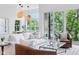 Bright living room featuring modern furniture, large windows, and access to an outdoor balcony at 2841 Tropical Dr, Indianapolis, IN 46205