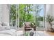 Living room area with large sliding glass doors, lake views, a neutral color scheme, and wood floors at 2841 Tropical Dr, Indianapolis, IN 46205