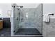 Walk-in shower boasts stone tile surround, black river rock floor, and dual shower heads at 2841 Tropical Dr, Indianapolis, IN 46205