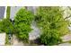 Aerial view of a backyard with a stone patio surrounded by lush green trees at 3106 N Harding St, Indianapolis, IN 46208