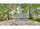 Backyard view of home featuring a gravel area and trees at 3106 N Harding St, Indianapolis, IN 46208