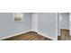 Bedroom featuring wood-look floors, light-blue walls, closet, and natural light from a window at 3106 N Harding St, Indianapolis, IN 46208