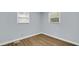 Clean corner bedroom showcasing new paint, a new window, and modern vinyl plank flooring at 3106 N Harding St, Indianapolis, IN 46208