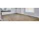 Updated kitchen featuring new white cabinets, stainless appliances, and spacious layout with vinyl plank flooring at 3106 N Harding St, Indianapolis, IN 46208