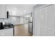 Updated kitchen and living space featuring stainless steel appliances and new vinyl plank flooring at 3106 N Harding St, Indianapolis, IN 46208