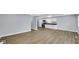 Bright kitchen and living space featuring stainless steel appliances, new white cabinetry, and vinyl plank flooring at 3106 N Harding St, Indianapolis, IN 46208