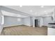 Open-concept living room with sleek stainless steel appliances, updated lighting, and modern vinyl plank flooring at 3106 N Harding St, Indianapolis, IN 46208