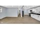 Open-concept living space featuring modern wood floors, neutral walls and white cabinets at 3106 N Harding St, Indianapolis, IN 46208