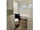 This bathroom has a sink with vanity, tub with shower and storage at 3325 Canaday Dr, Anderson, IN 46013
