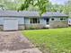 Charming single-story home with a well-maintained lawn and attached garage at 3325 Canaday Dr, Anderson, IN 46013