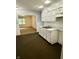 Classic kitchen features white cabinets, contrasting dark floors, and an open layout at 3325 Canaday Dr, Anderson, IN 46013