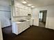 Classic kitchen features white cabinets, contrasting dark floors, and ample counter space at 3325 Canaday Dr, Anderson, IN 46013