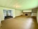 A spacious living room features carpeted floors, a brick fireplace, and an open layout at 3325 Canaday Dr, Anderson, IN 46013