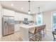 Well-lit kitchen featuring stainless steel appliances, a kitchen island with seating, and a modern design at 354 N Grand Oak Dr, Mooresville, IN 46158