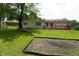 Lush backyard featuring a brick home exterior with a deck and fire pit, perfect for entertaining at 3612 Carolee Ct, Indianapolis, IN 46227