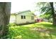 Backyard view showcasing the home's exterior, a small deck, and a swing set at 3612 Carolee Ct, Indianapolis, IN 46227