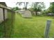 Fenced backyard with mature trees, green grass, and shed featuring easy access and ample space at 3612 Carolee Ct, Indianapolis, IN 46227