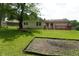 A spacious backyard, featuring a red deck, and mature trees at 3612 Carolee Ct, Indianapolis, IN 46227