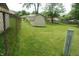 Fenced backyard with mature trees, green grass, and shed featuring easy access and ample space at 3612 Carolee Ct, Indianapolis, IN 46227