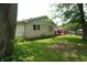 Green backyard featuring a brick home exterior with a wood deck and swing set at 3612 Carolee Ct, Indianapolis, IN 46227